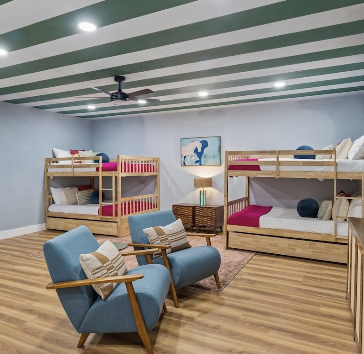 The bunk salon — four bunks under a green-striped ceiling