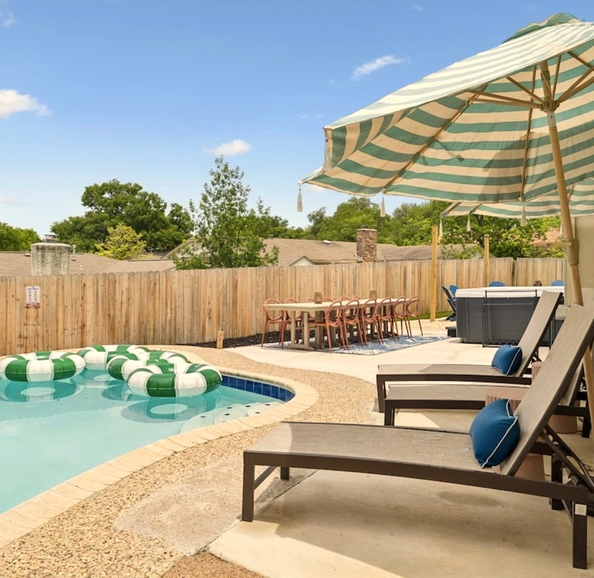 The heated pool under a striped umbrella